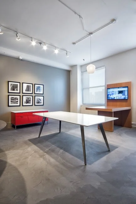 Flat Iron table with white table top and obsidian finished base