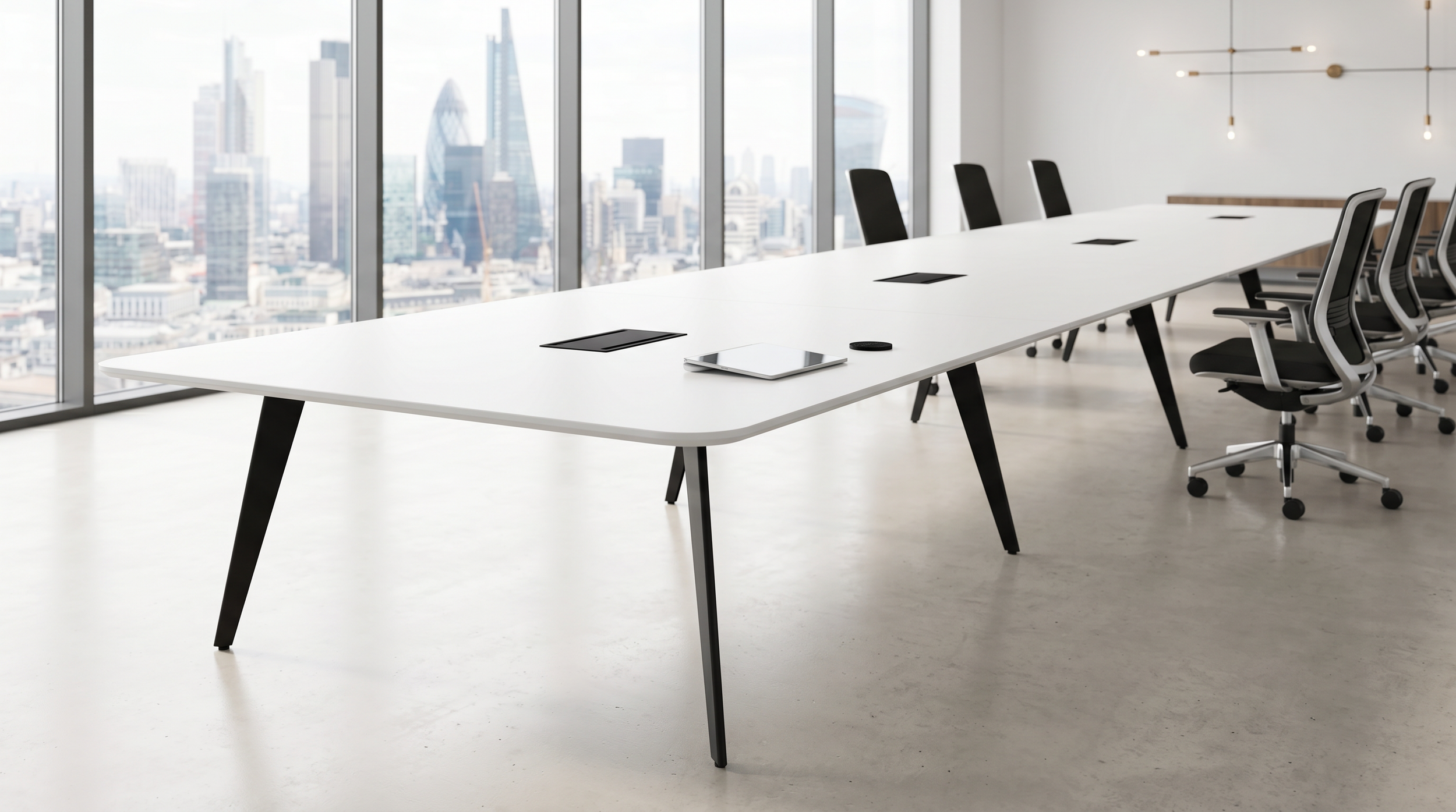 Long Flatiron conference room table with white tabletop and chrome base.
