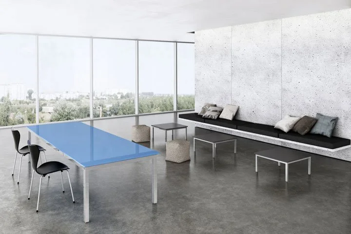 Blue painted back glass tabletop with brushed aluminum base Parsons community table.