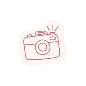 Sketch of a camera with lines indicating flash or light action.