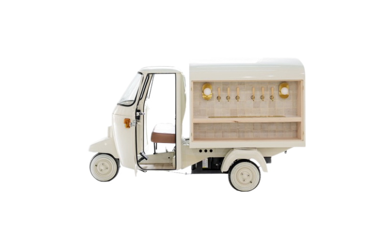 Miniature white vehicle with a display case on the back containing hanging utensils and small decorative items.