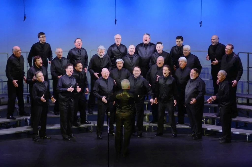 Crimson Pride Choris singing on stage during a performance.
