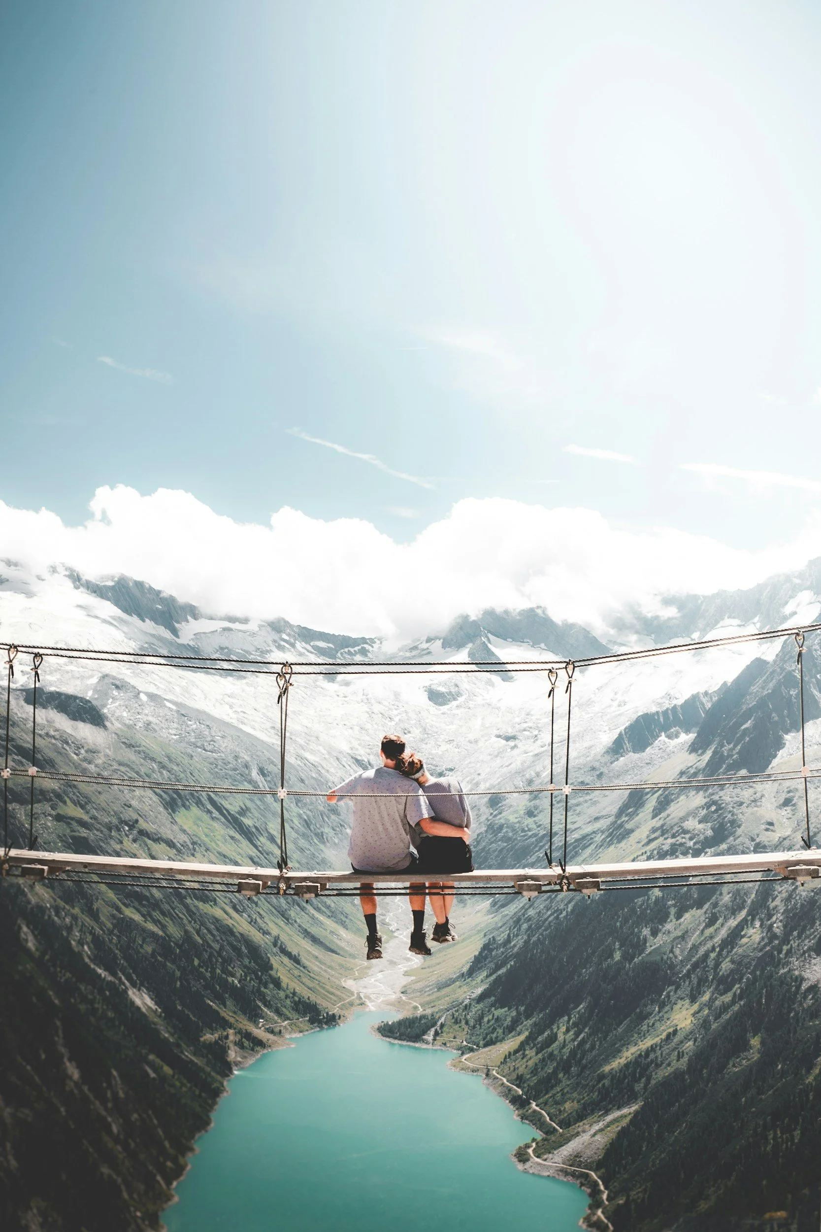 A couple sitting on a bridge reflecting after a couples therapy intensive in Raleigh, NC