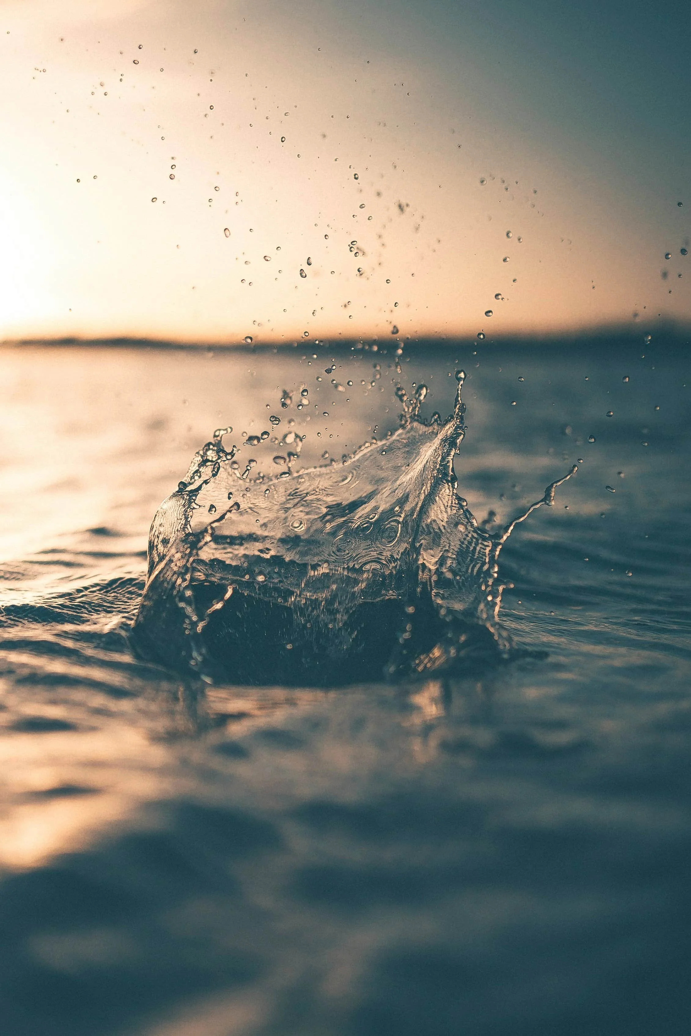 A close-up of a water splash at sunrise or sunset, symbolizing the clarity and forward movement supported through therapy fees in Raleigh, NC.