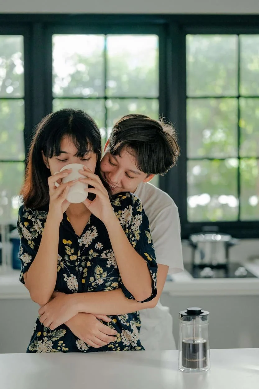 A connected couple sharing a warm moment at home, reflecting the relationship support offered through couples therapy in Raleigh, NC.