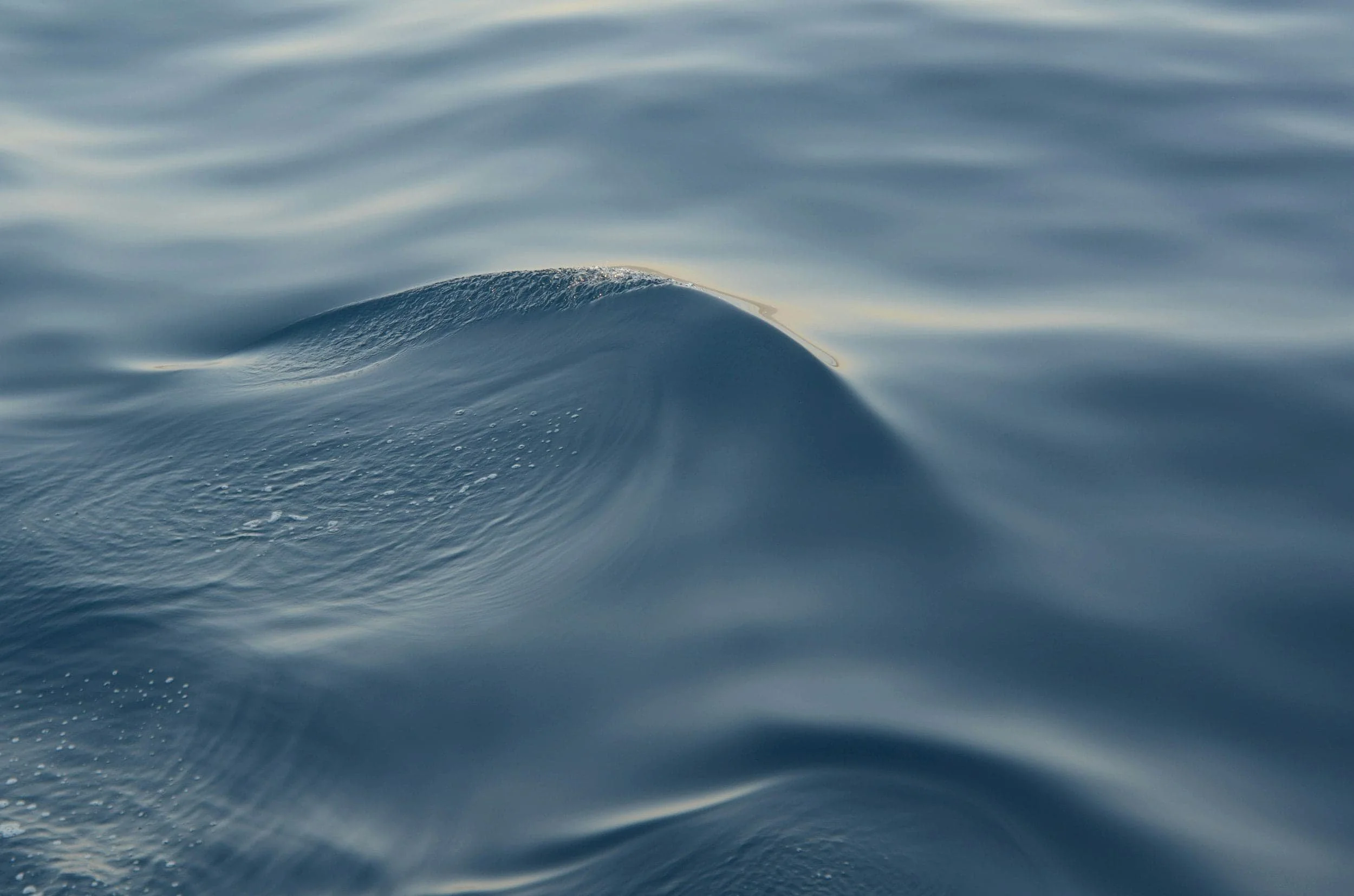 Close-up of ocean water with gentle waves and a small splash.