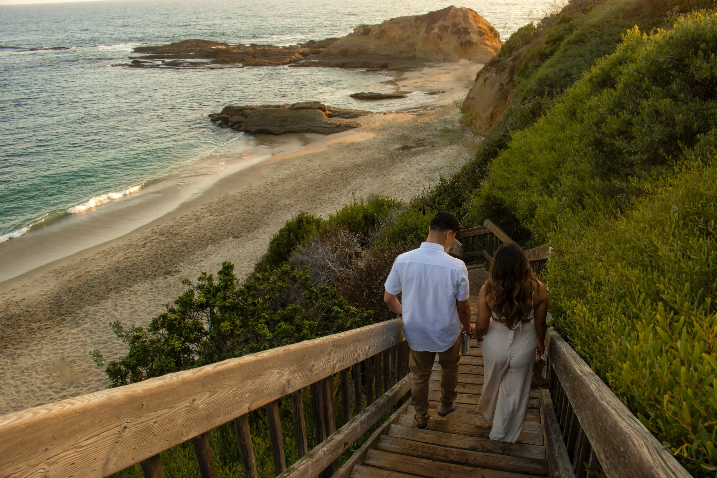 A couple walking toward the beach at sunset, symbolizing the clarity, connection, and renewed partnership supported through couples therapy.