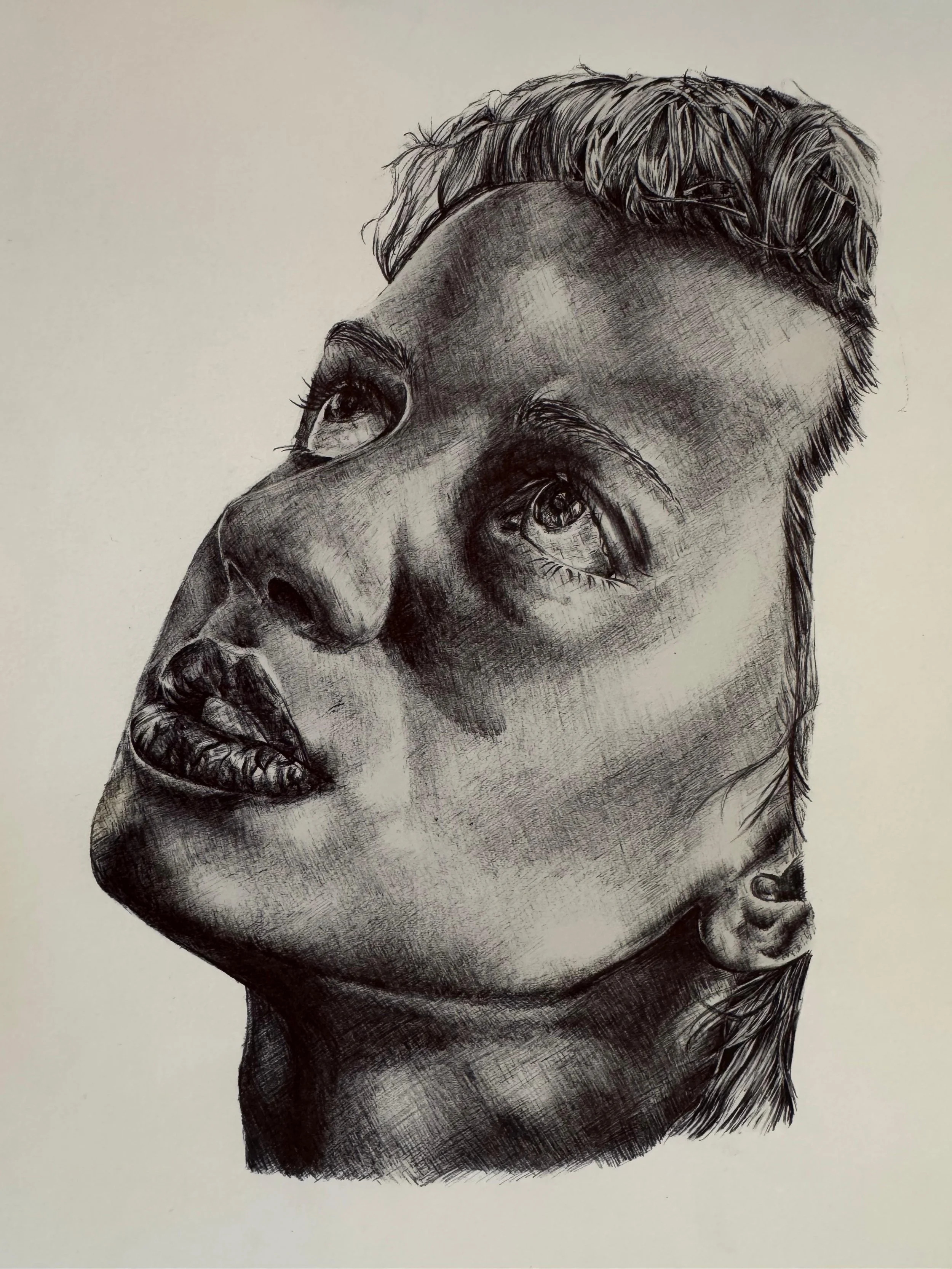 Black and white portrait sketch of a woman's face, with detailed shading, looking upwards with a contemplative expression.