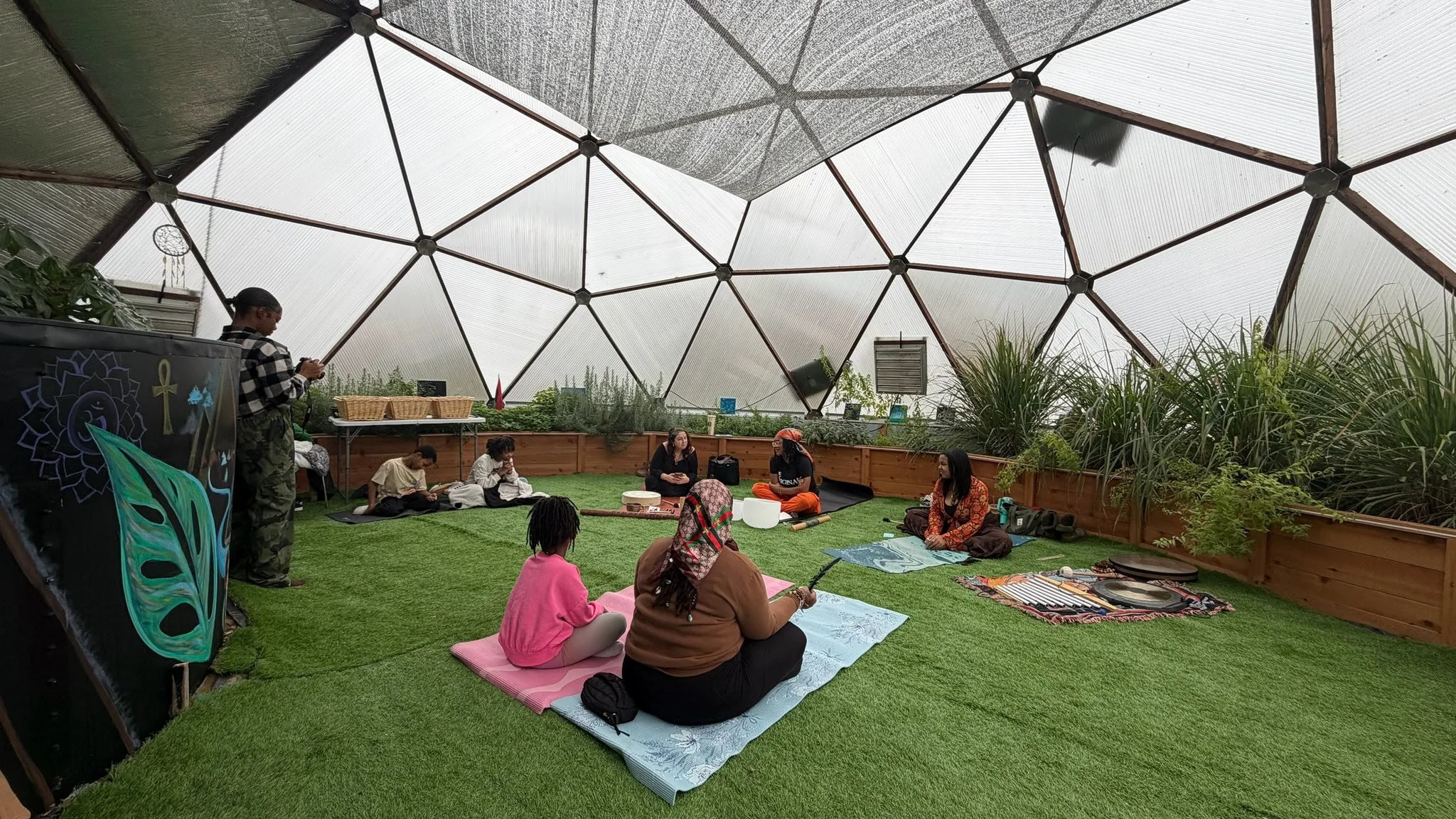A group of people participating in a meditation and sound healing event in the POD in northeast ohio 