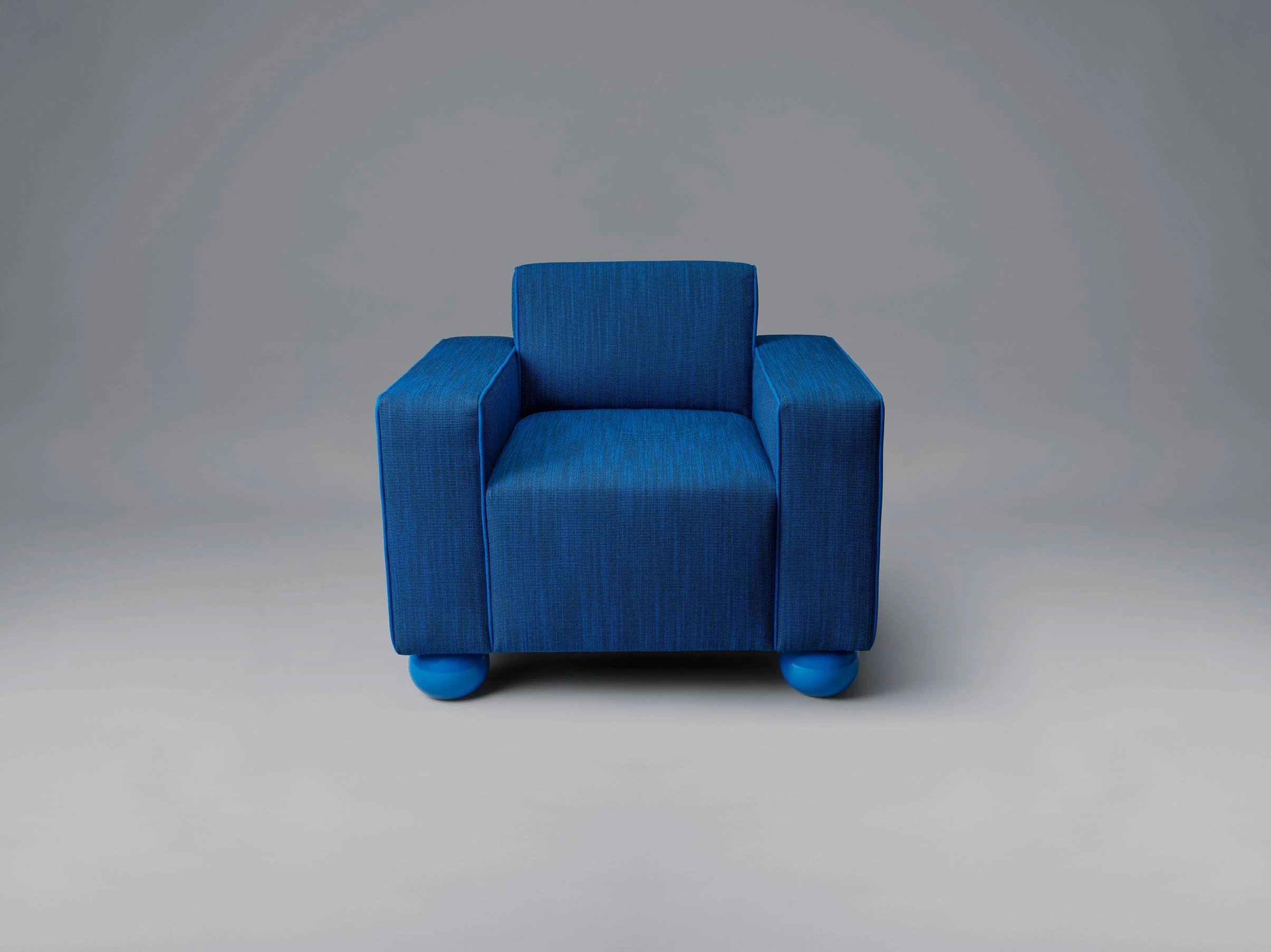 Blue armchair with rounded blue feet against a plain gray background.