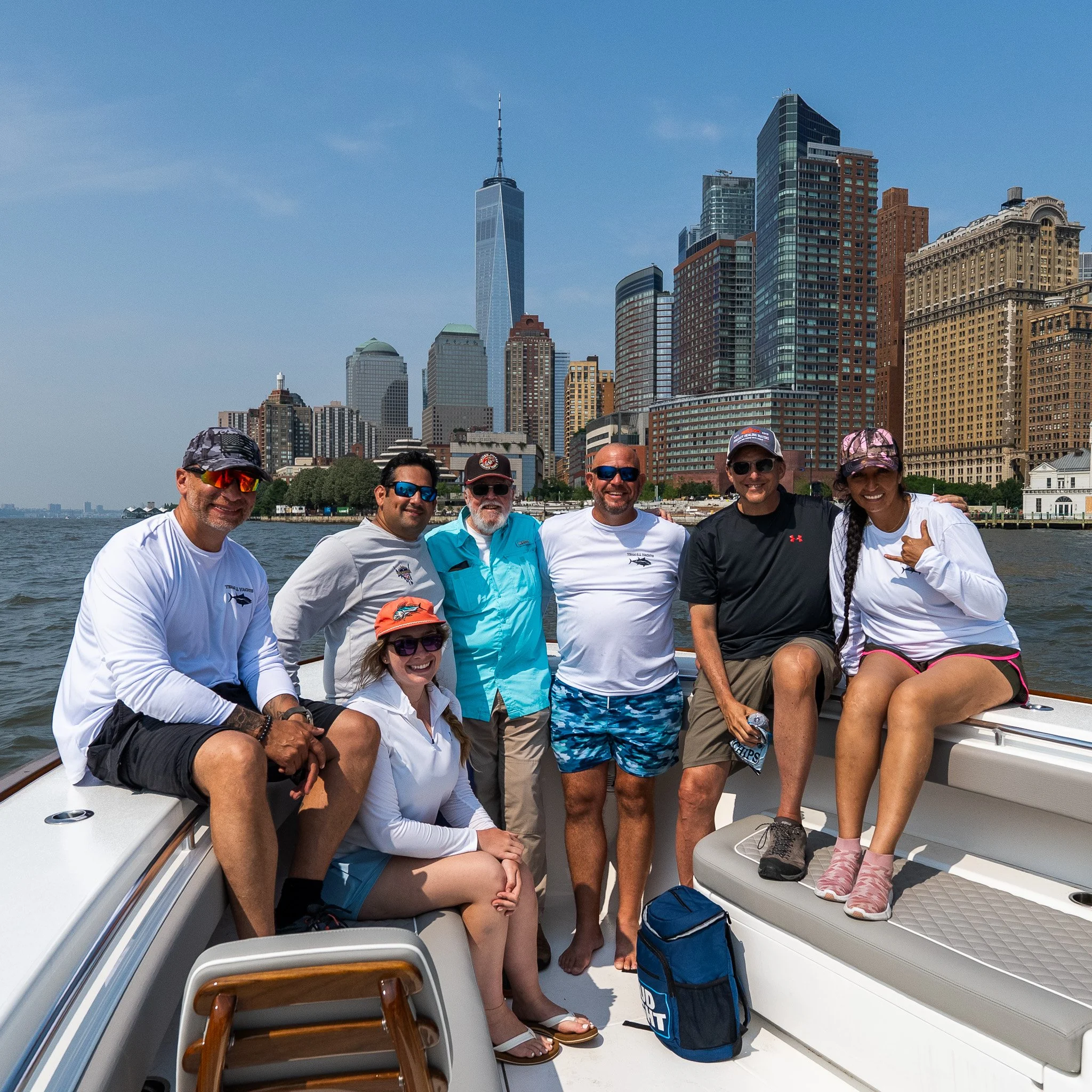 Photographer sunset boat cruise with New York City skyline in the background.