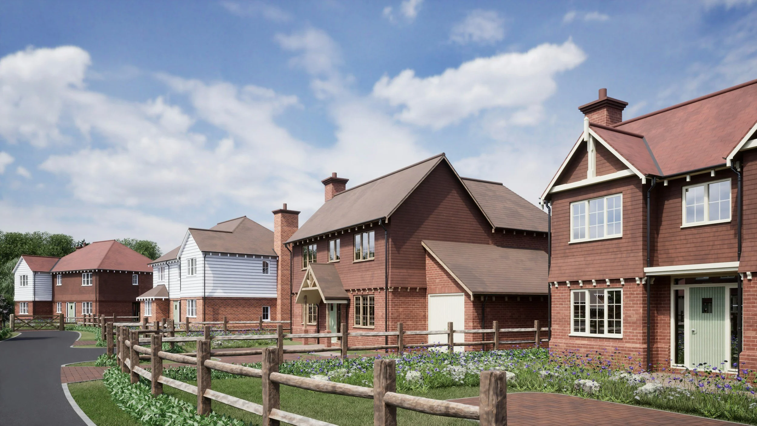 A row of modern brick houses with gardens on a bright day with partly cloudy sky.
