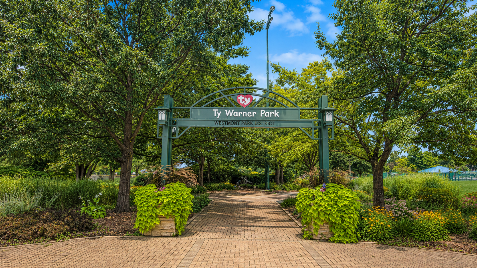 Ty Warner Park entrance in Westmont, Illinois, with landscaped gardens and walking paths