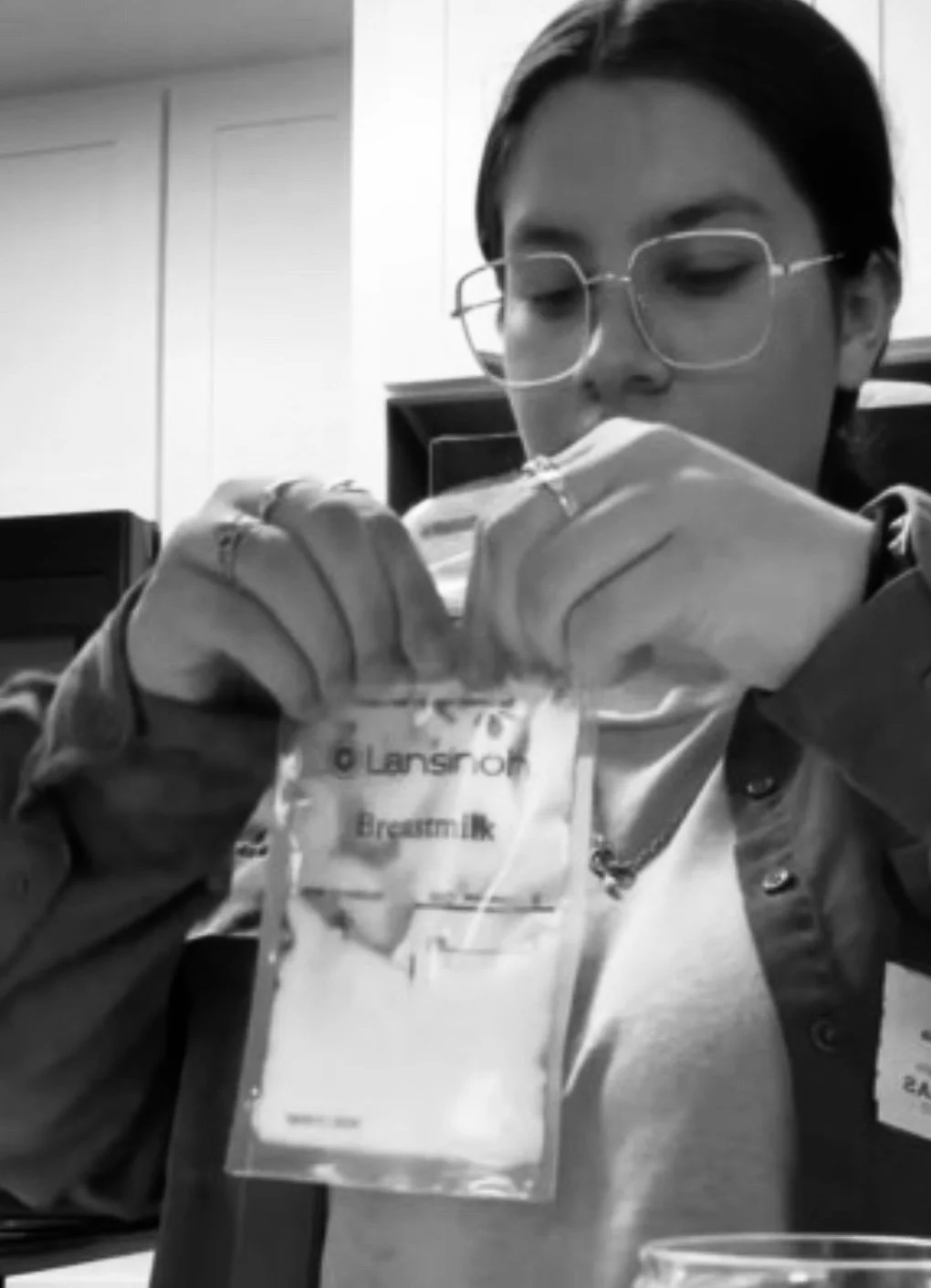 Krissa the Doula assisting a postpartum client by safely bagging and storing breast milk, demonstrating practical postpartum doula support for families in Central Texas