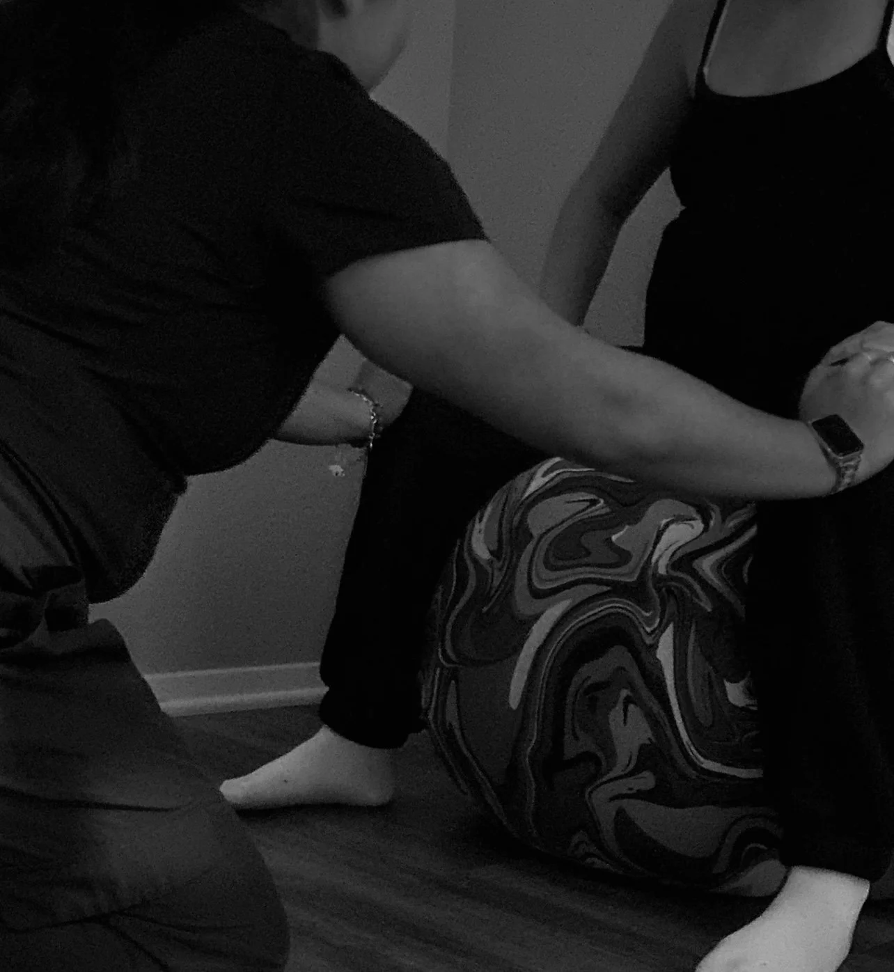 Krissa the Doula providing hands-on counterpressure to a laboring client during childbirth, offering physical comfort measures and continuous birth doula support in Central Texas