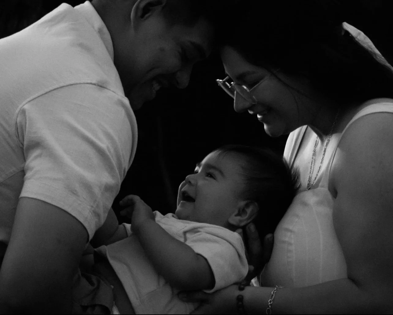 two first time parents holding their baby after their experience with a birth doula and postpartum doula. they had support they needed