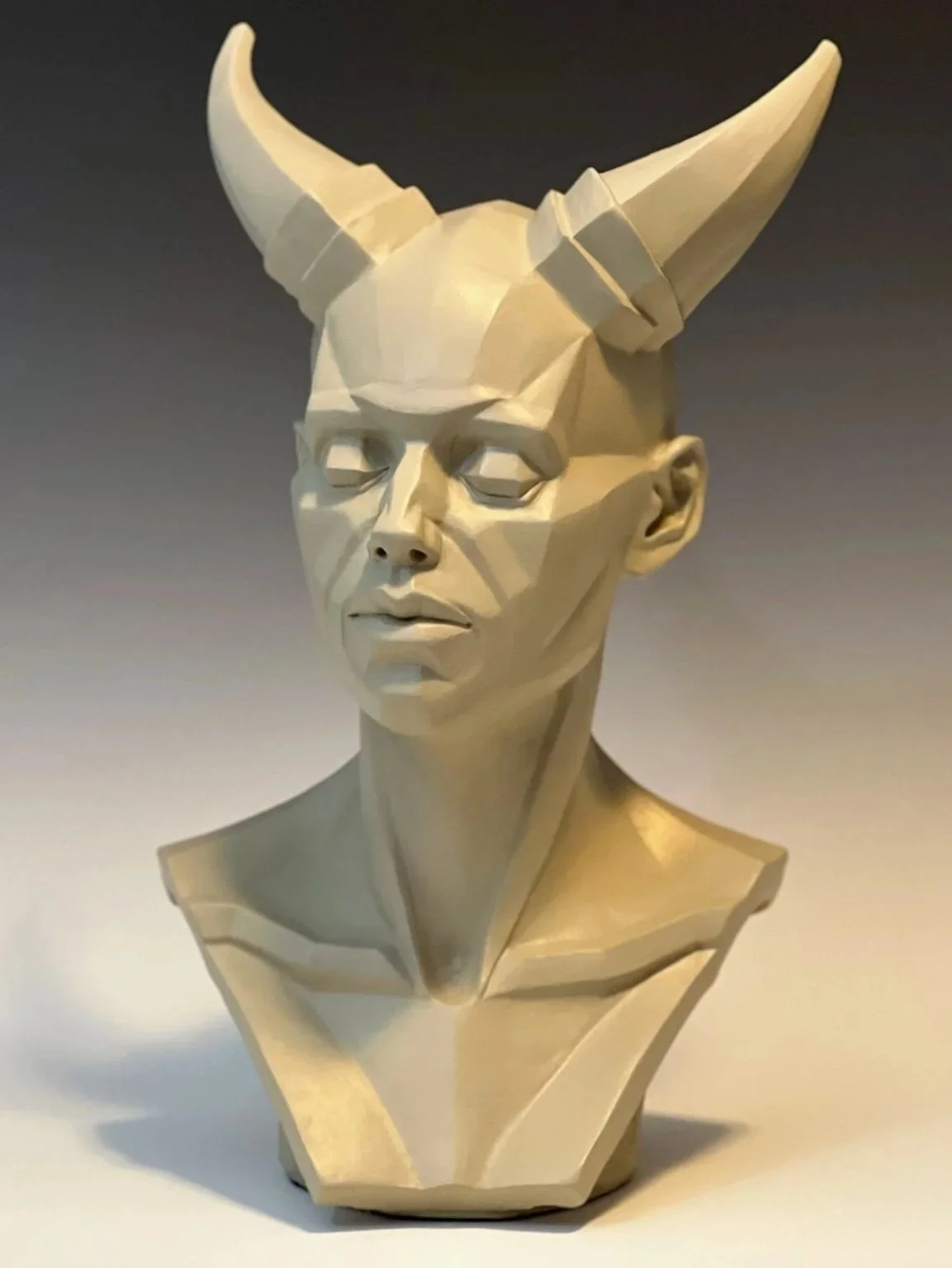 Androgenous plaster sculpture made of planes with large pair of horns