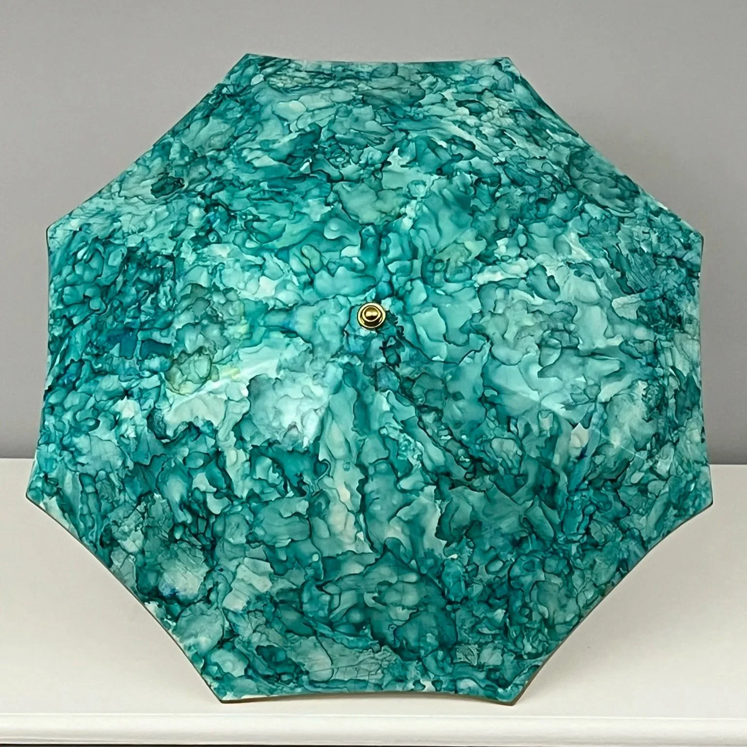 Large ceramic umbrella finished with alcohol ink to give a deep green pattern