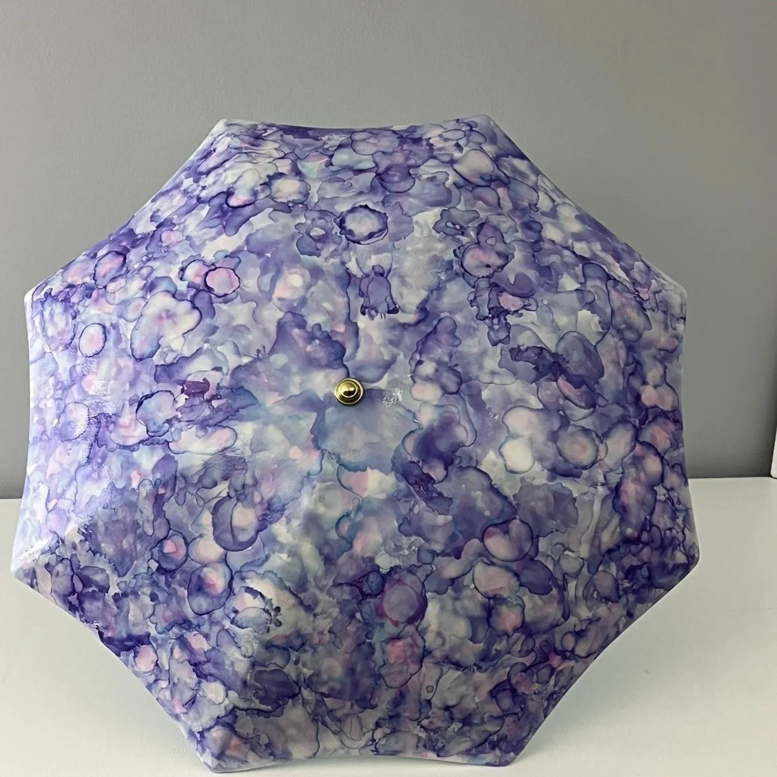 Large ceramic umbrella with a mottled purple pattern that provides depth and intrigue