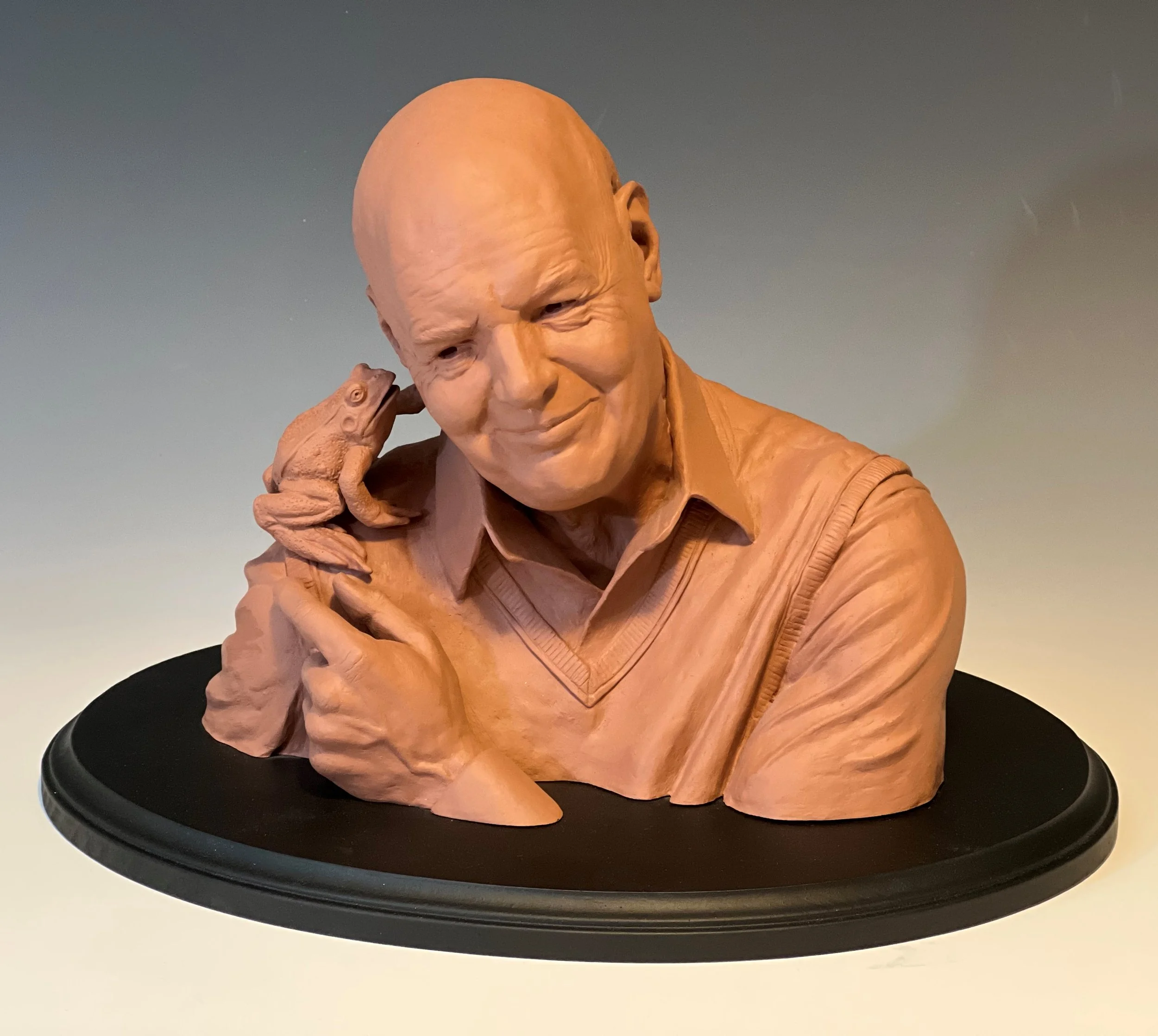 Sculpture of a kindly old man talking to a frog