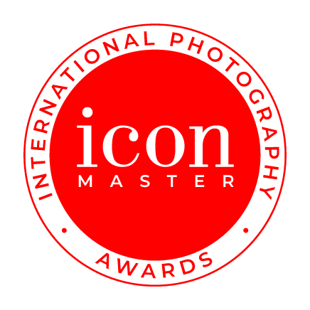 Red circular badge with black border, featuring the words 'International Photography Awards' around the edge and the text 'icon master' in the center.