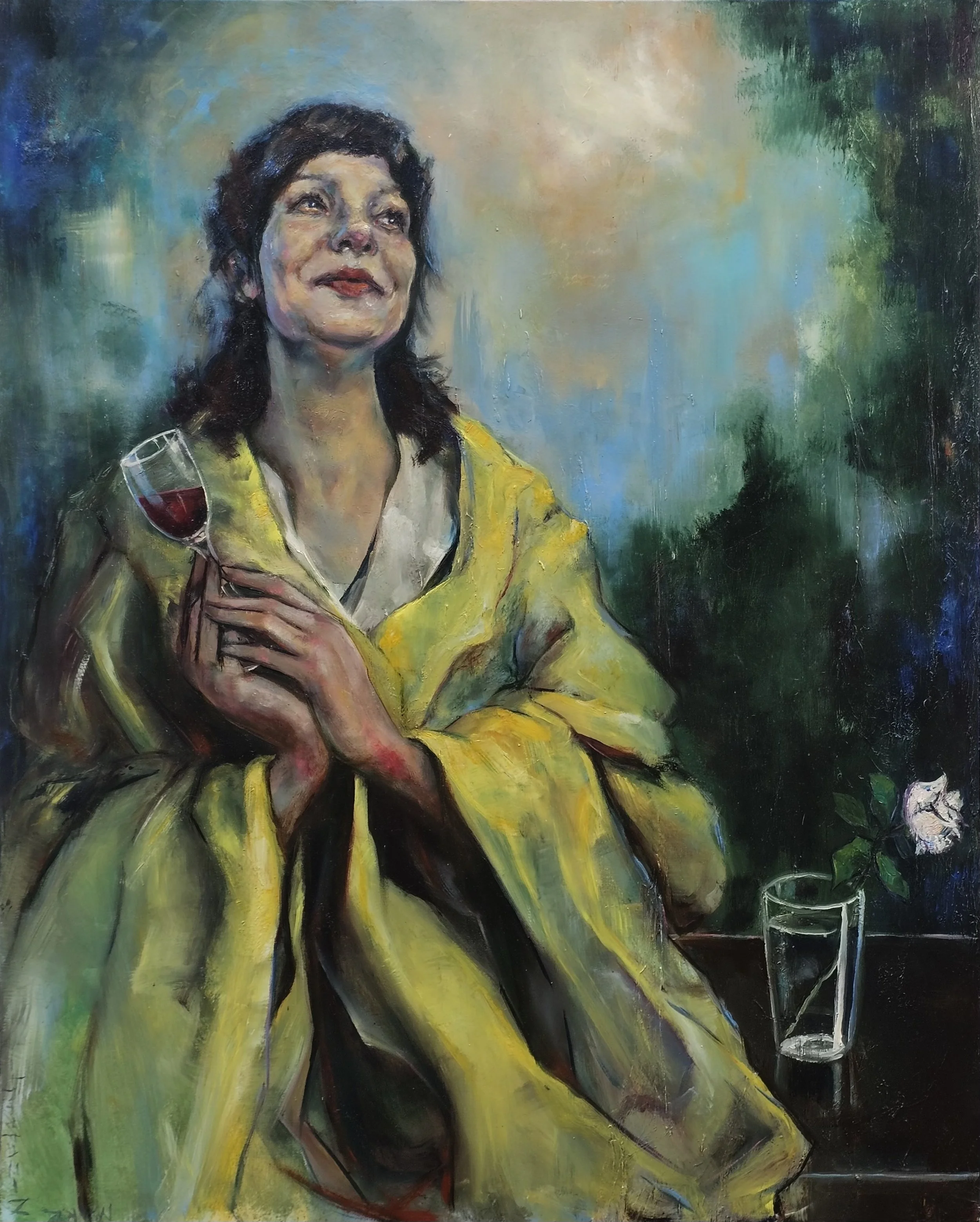 A woman in a yellow coat holding a glass of red wine, with a white rose in a glass on a table beside her.