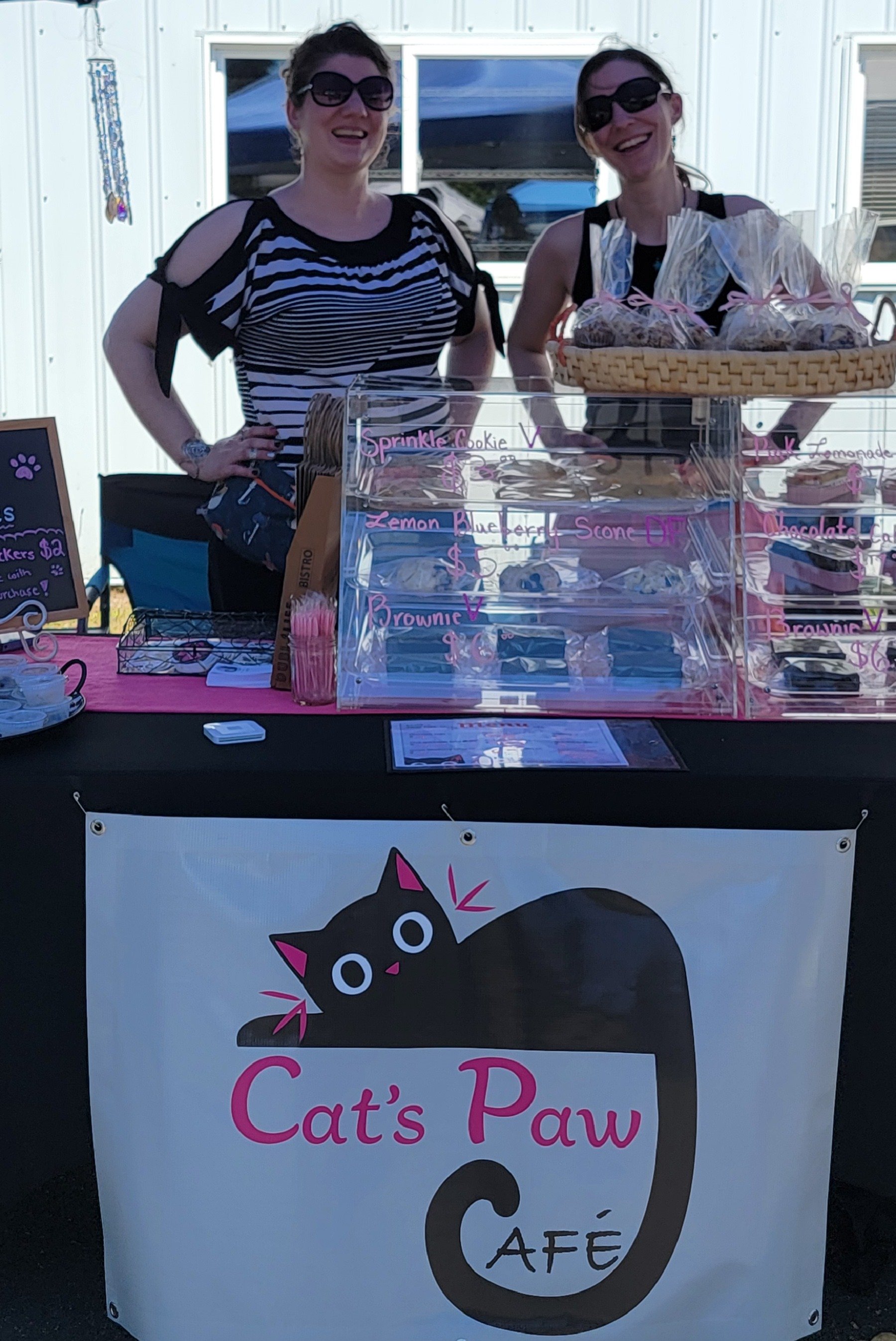 cats paw cafe owners at the market
