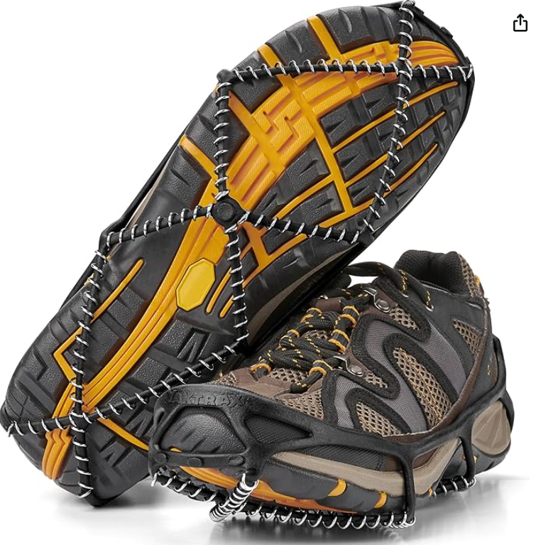 A hiking shoe with a traction device attached, featuring black and yellow rugged soles and a cushioned upper with brown, black, and tan details.