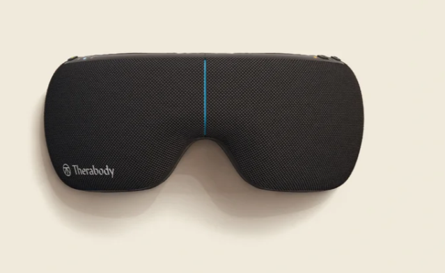 Black Therabody sleep mask with built-in speakers and a blue line running vertically in the center.