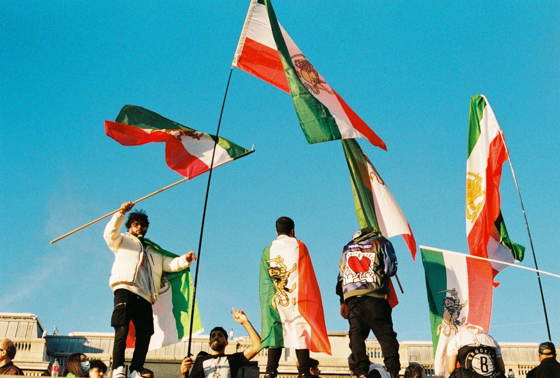 People holding and waving Italian flags at a gathering or event.