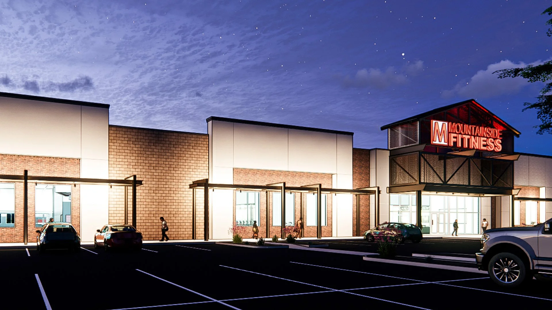 Nighttime exterior view of Mountainside Fitness gym with a parking lot, cars, and people walking toward the entrance, illuminated by building lights and a red neon sign.
