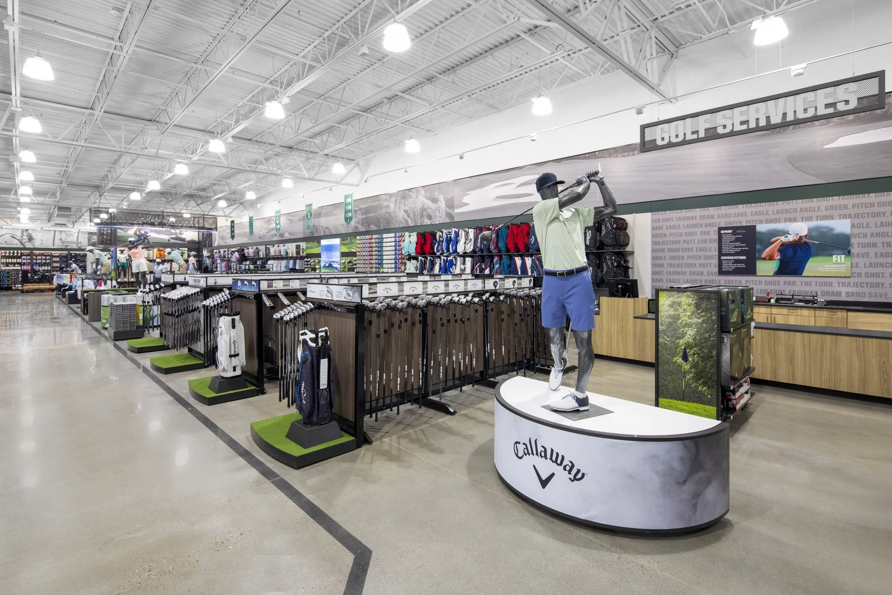 Golf club display and golf accessories in a retail store.