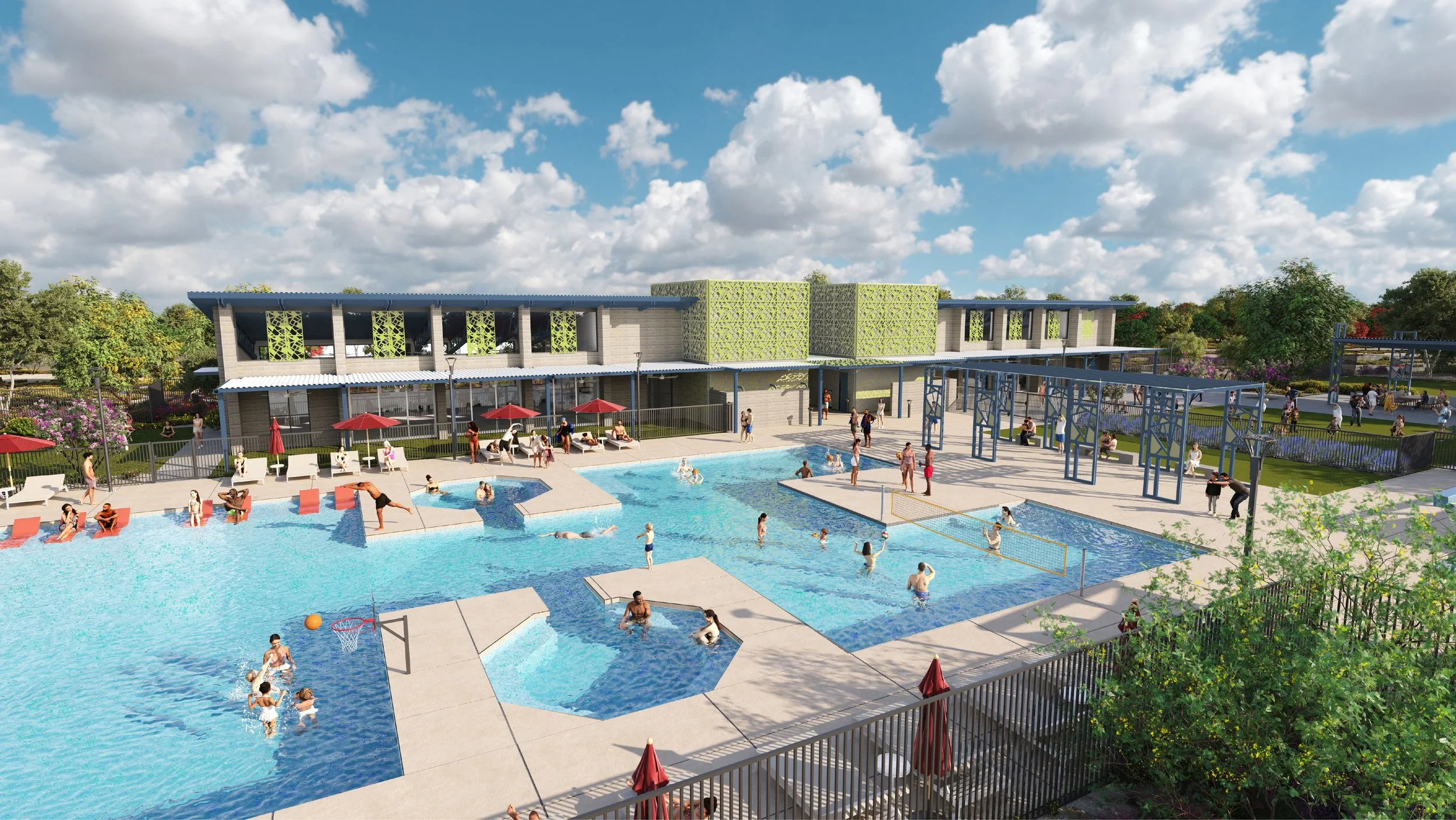 A busy outdoor community swimming pool area with children and adults swimming and playing, surrounded by lounge chairs with red umbrellas, a modern building in the background, and green landscaping under a partly cloudy sky.