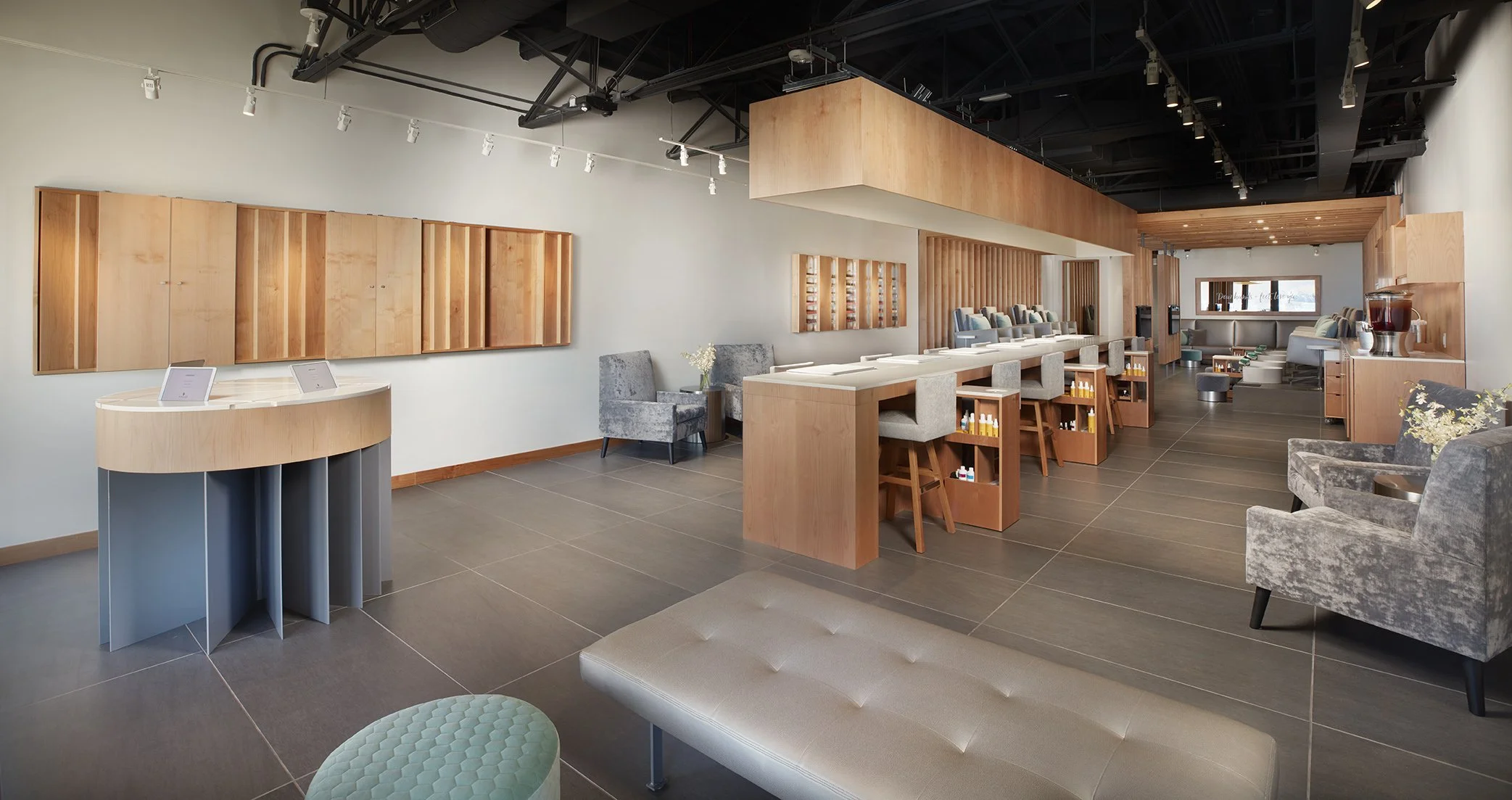 Lobby or waiting area with chairs, tables, and wooden decor in a modern style.