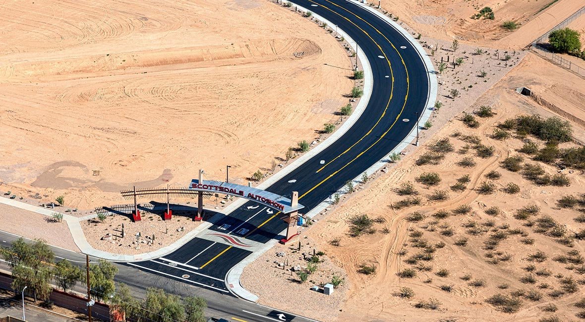 Aerial view of a newly constructed road at Scottsdale Road with a welcome sign for Scottsdale Auto Body.