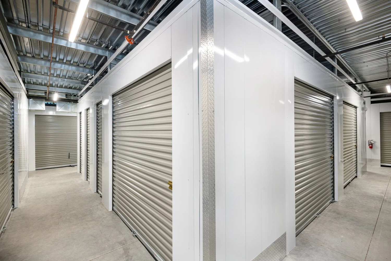 Storage units with closed metal roll-up doors in a commercial storage facility