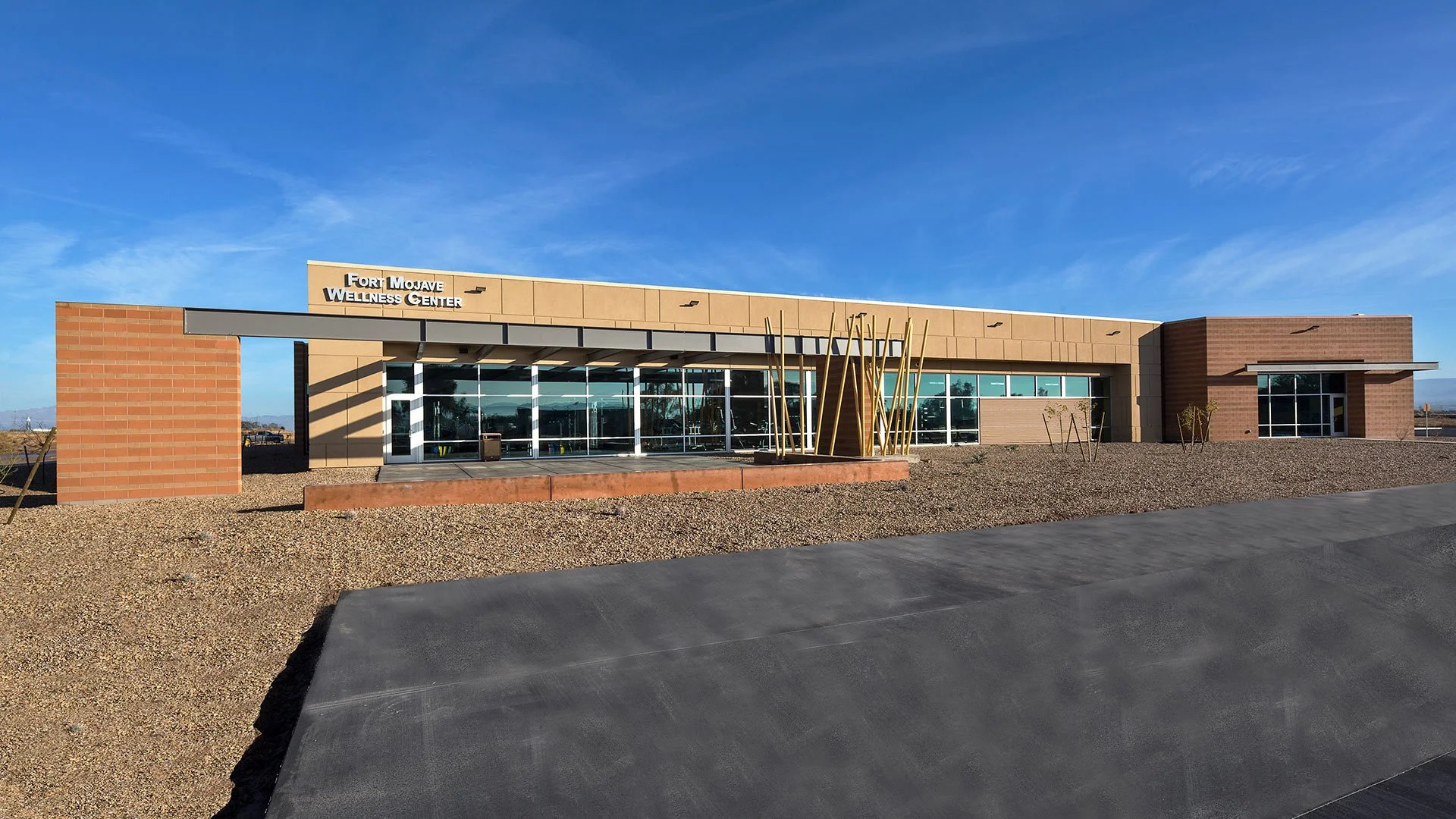 Exterior view of the Fort Mojave Wellness Center building with a clear blue sky.