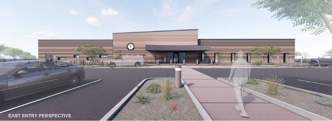Digital rendering of a modern community center with a parking lot and landscaped walkways, seen from the east entry view.