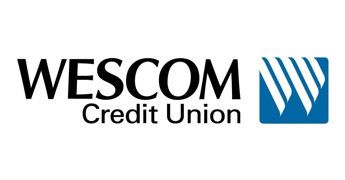 Logo of WESCOM Credit Union with the text 'WESCOM Credit Union' and a blue emblem with white diagonal stripes.