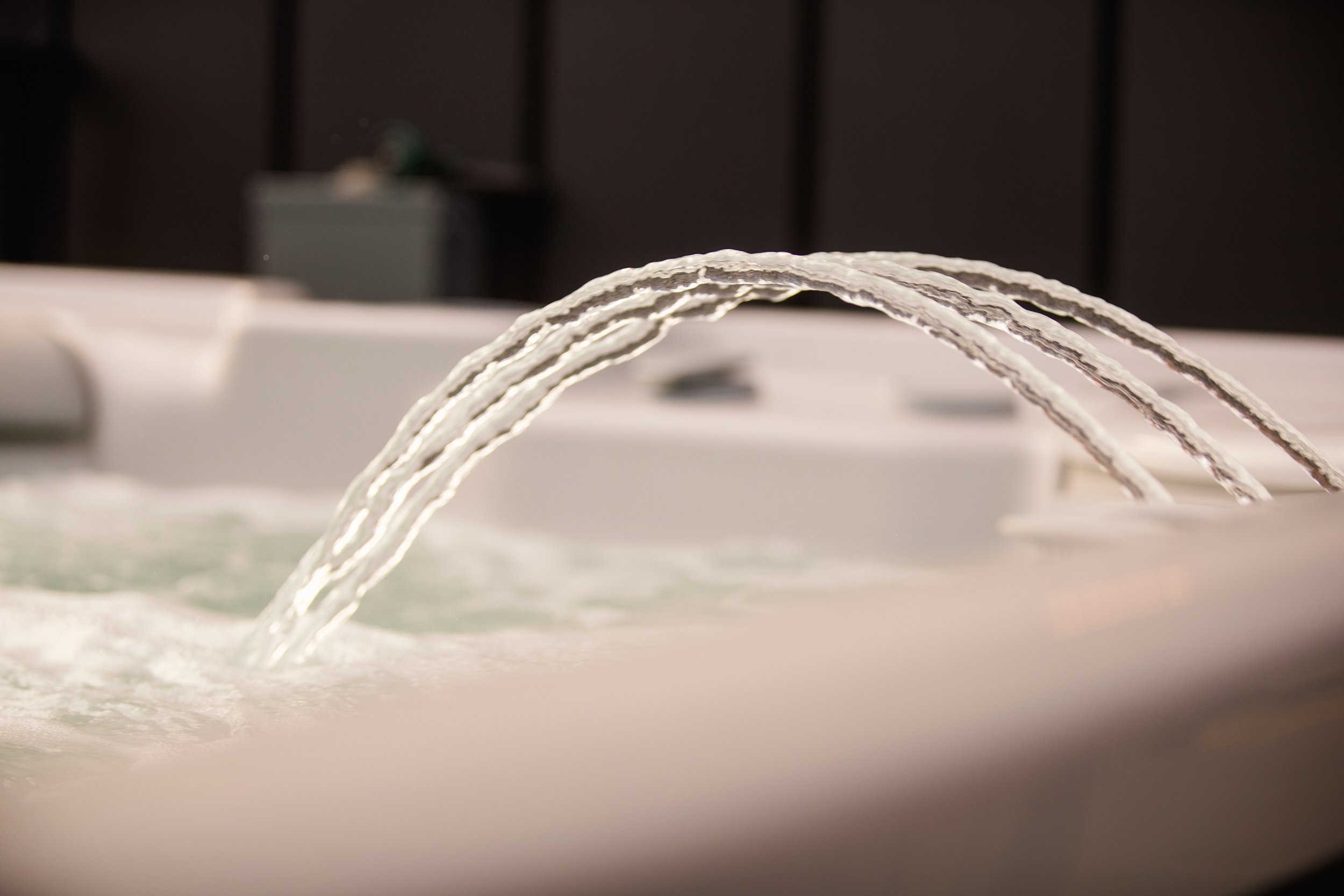 Close-up of water jets flowing into a hot tub or spa.