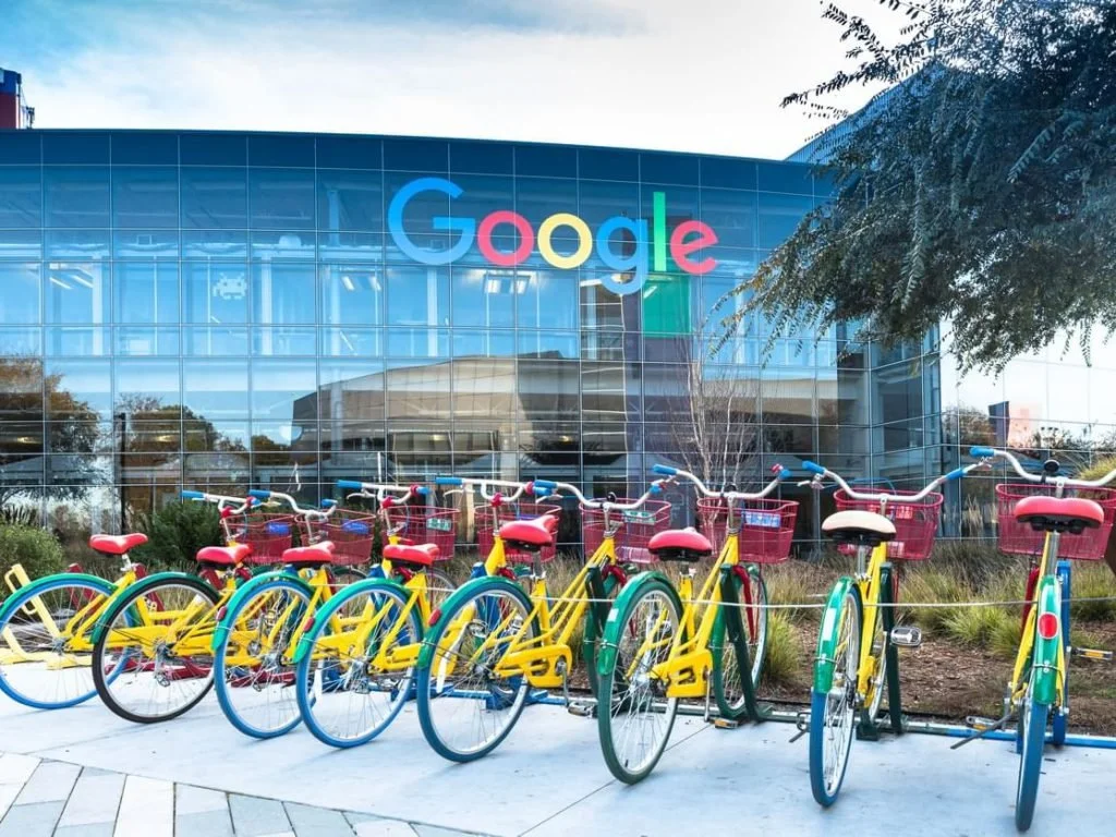 Front of Google Palo Alto campus with a row of eight colorful google colored bikes.