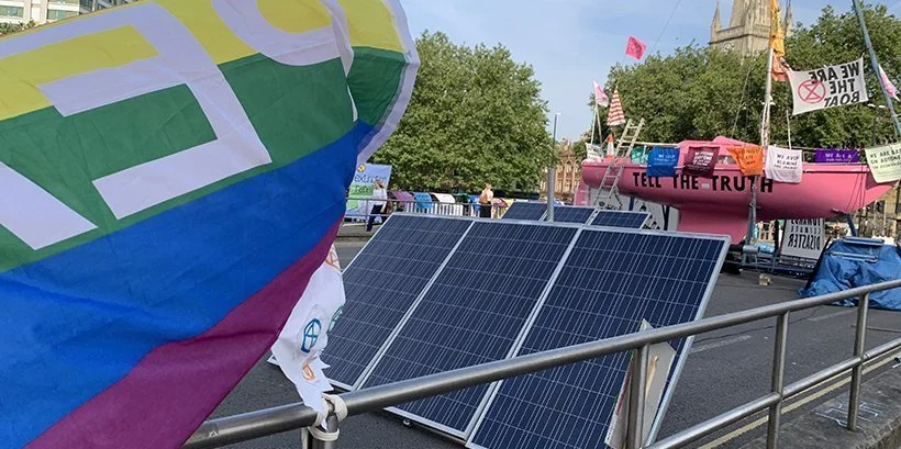 Extinction Rebellion protests in Bristol, pink ship with words "Tell the Truth"