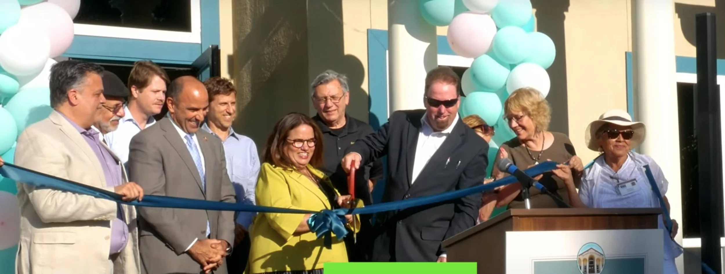 A group of people for a ribbon cutting ceremony at San Benito Community Clinic