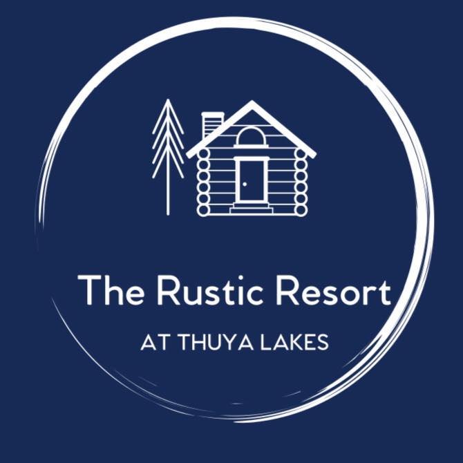 Logo for The Rustic Resort at Thuya Lakes featuring a log cabin and pine tree design on a dark blue circular background.
