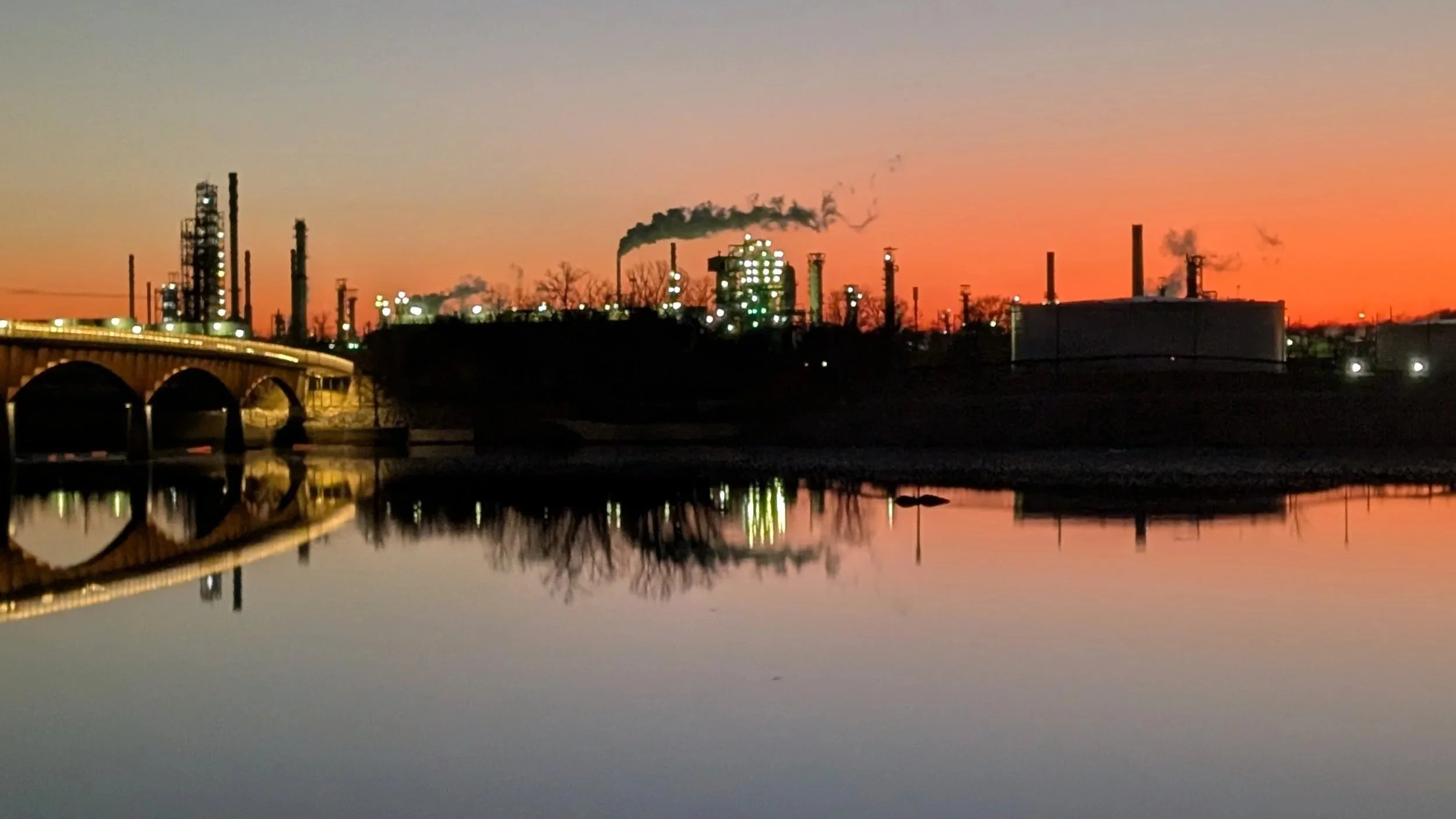 The Arkansas River at sunset, looking out at the refinery on the river.