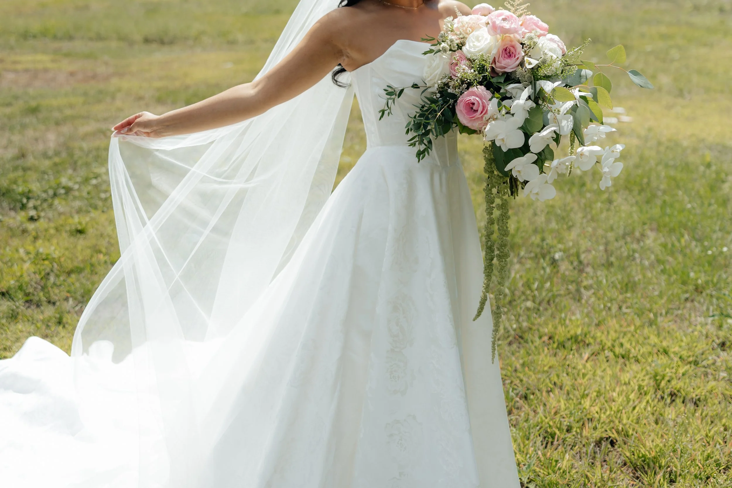 Bridal details with muted colorful floral bouquet, veil, wedding dress, backyard wedding getting ready.