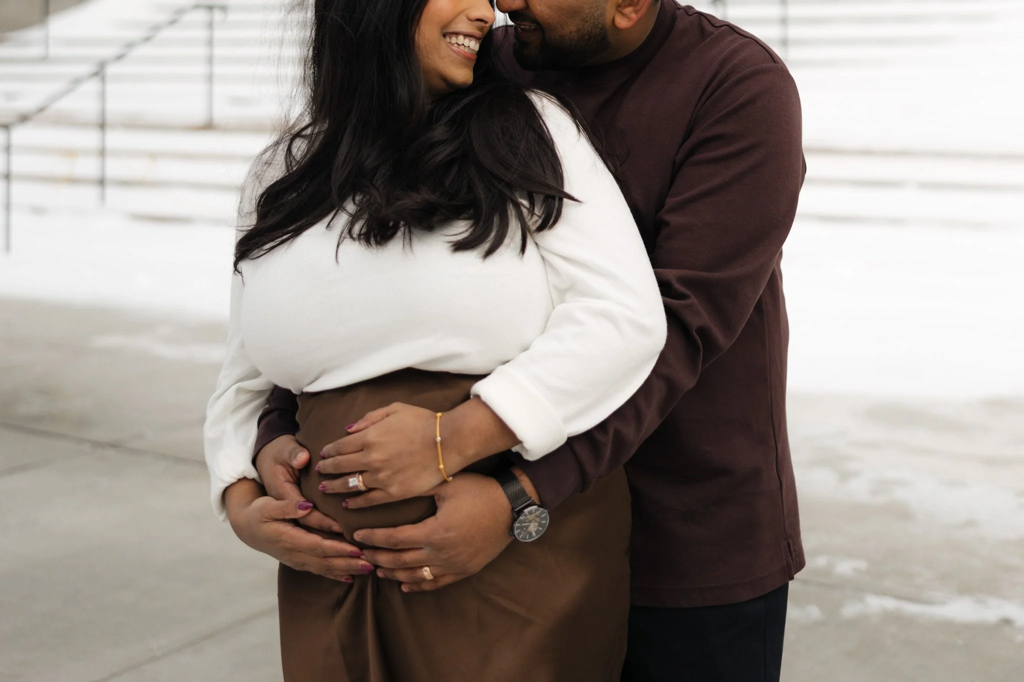 Maternity session in Downtown Detroit snow mid winter due date, cozy and smiling candid film.