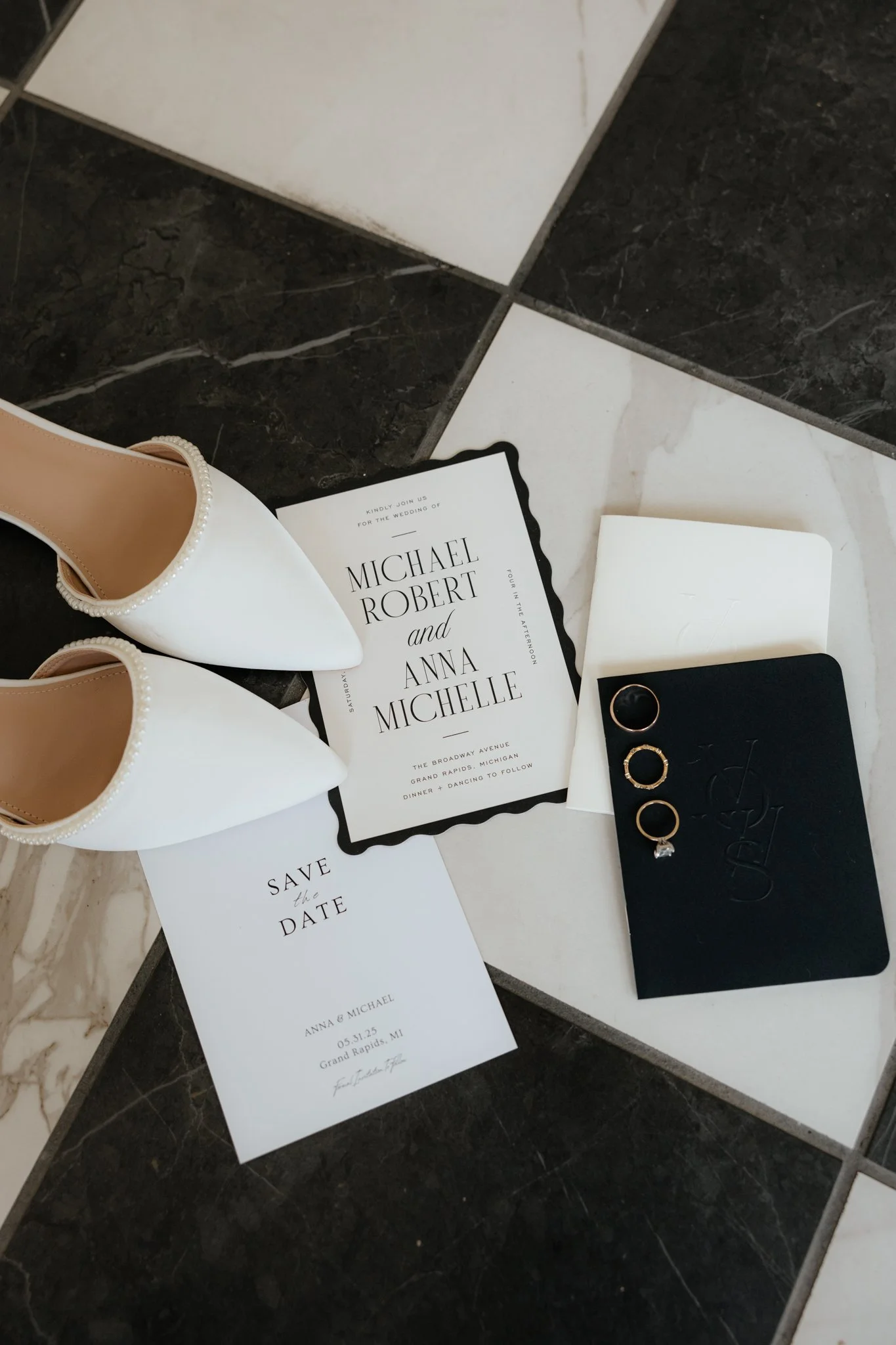 Wedding details, black and white classy elegant simple planning. Wedding rings and bands with bridal shoes and wedding invites at The Broadway Avenue in Grand Rapids, Michigan.