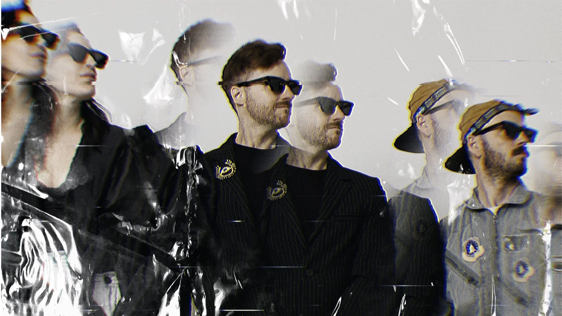 Group of three people standing side by side, wearing sunglasses, with hands clasped. They are dressed in stylish modern clothing. The image has a distorted, prism effect.