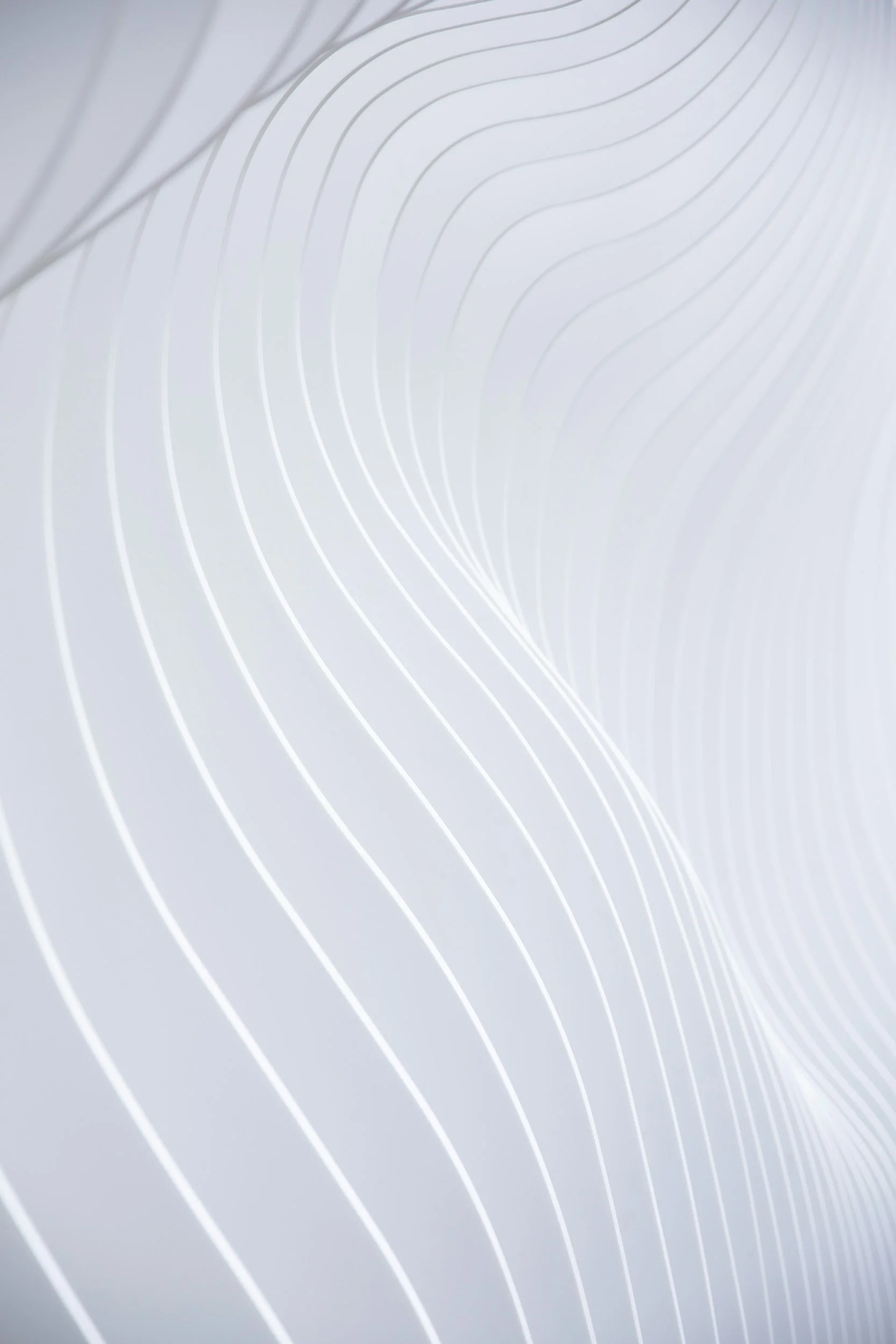 Abstract white background with curving thin white lines creating a flowing pattern.